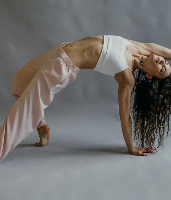 Woman in a calm, controlled yoga pose, feeling flexible.